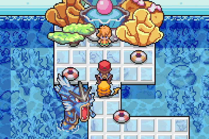 The trainer and companion approach Misty beneath a colorful aquatic display